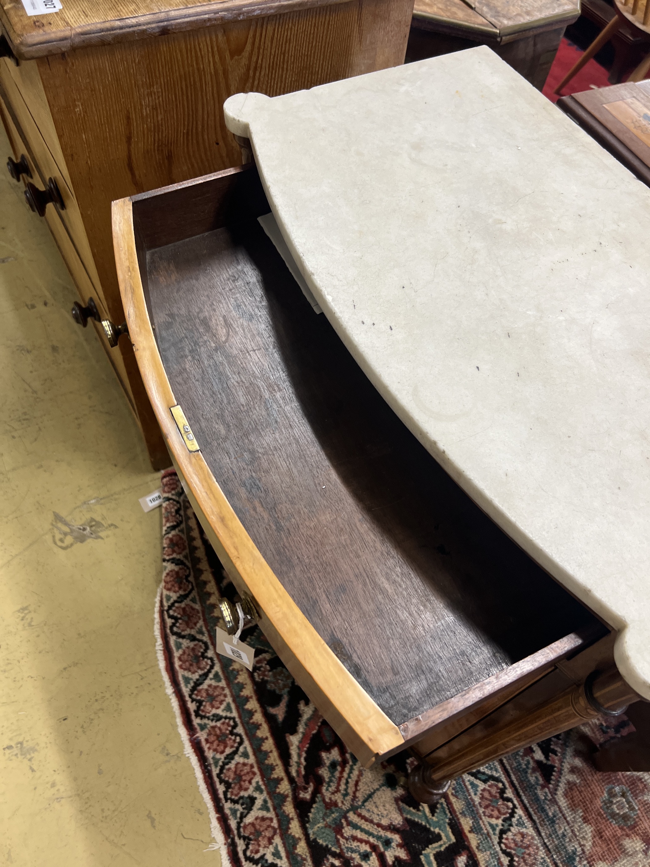 A George III Sheraton style faded rosewood bow front marble top side cabinet, width 65cm, depth 35cm, height 89cm